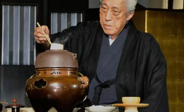 Genshitsu Sen, a grand master of the Urasenke school of Japanese tea ceremony, conducts a tea ceremony during an event in Shanghai, China, March 15, 2014. (Kyodo News via AP)