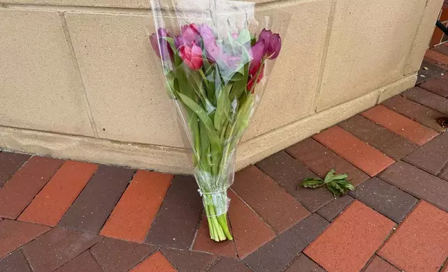 A lone bouquet sits outside a CVS pharmacy on Saturday, Aug. 9, 2025, near where police say a man was shooting at the headquarters of the U.S. Centers for Disease Control and Prevention in Atlanta (AP Photo/Jeff Amy)