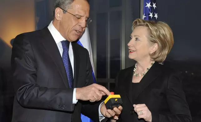 FILE - U.S. Secretary of State Hillary Clinton, right, presents Russian Foreign Minister Sergey Lavrov with a device with a red button symbolizing the intention to "reset" U.S.-Russian relations during their meeting in Geneva, Switzerland on March 6, 2009. (AP Photo, File)