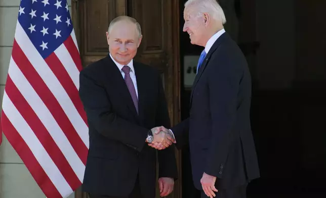 FILE - Russian President Vladimir Putin, left, and U.S President Joe Biden shake hands in Geneva, Switzerland, on June 16, 2021. (AP Photo/Alexander Zemlianichenko, Pool, File)