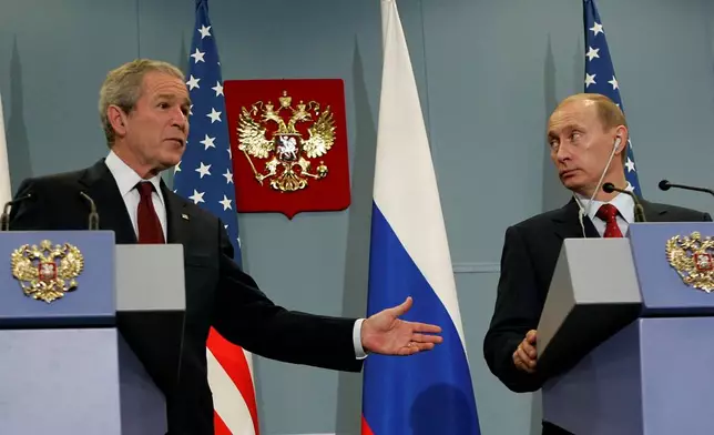 FILE- Russian President Vladimir Putin, right, and U.S. President George W. Bush look on during their news conference in the Black Sea resort city of Sochi, southern Russia, Sunday, April 6, 2008. (AP Photo/Alexander Zemlianichenko, File)