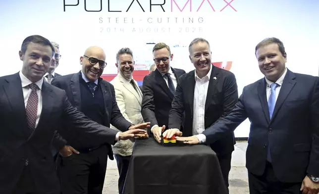 Canada's and Finland's representatives pose for a group photo during a steel cutting ceremony for the beginning of construction of the Polar Max Icebreaker in Helsinki Shipyard in Helsinki, Finland, Wednesday, Aug. 20, 2025. (Markku Ulander/Lehtikuva via AP)