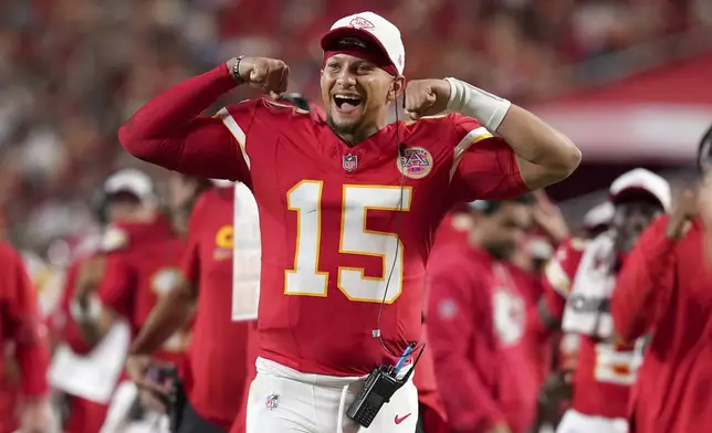 Kansas City Chiefs quarterback Patrick Mahomes cheers from the sidelines during the second half of a preseason NFL football game against the Chicago Bears Friday, Aug. 22, 2025, in Kansas City, Mo. (AP Photo/Ed Zurga)
