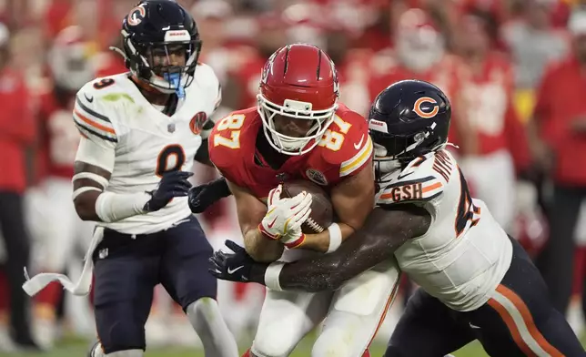 Kansas City Chiefs tight end Travis Kelce (87) is stopped by Chicago Bears linebacker Ruben Hyppolite II, right, as defensive back Jaquan Brisker (9) watches during the first half of a preseason NFL football game Friday, Aug. 22, 2025, in Kansas City, Mo. (AP Photo/Charlie Riedel)