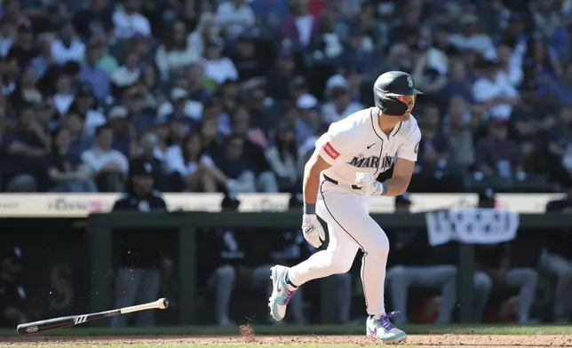 Seattle Mariners' Dominic Canzone heads to first after hitting an RBI single to score Eugenio Suárez for a walkoff win during the 11th inning of a baseball game against the Chicago White Sox, Thursday, Aug. 7, 2025, in Seattle. (AP Photo/Jason Redmond)