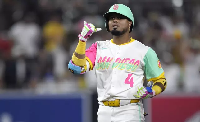 San Diego Padres' Luis Arraez celebrates after hitting a double during the eighth inning of a baseball game against the Los Angeles Dodgers, Friday, Aug. 22, 2025, in San Diego. (AP Photo/Orlando Ramirez)