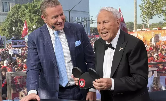 Lee Corso, right, and Kirk Herbstreit work on the set of ESPN's "College GameDay," before the NCAA college football game between Ohio State and Texas, Saturday, Aug. 30, 2025, in Columbus, Ohio (AP Photo/Jospeh Reedy)