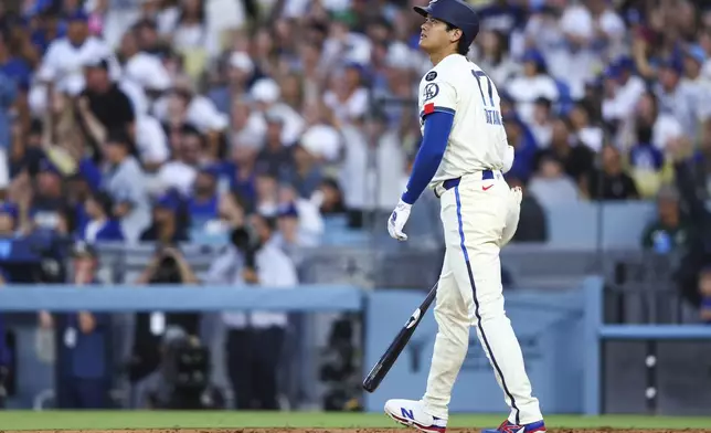 Los Angeles Dodgers' Shohei Ohtani watches his home run during the fifth inning of a baseball game against the Toronto Blue Jays, Saturday, Aug. 9, 2025, in Los Angeles. (AP Photo/Jessie Alcheh)