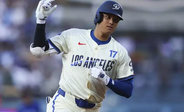 Los Angeles Dodgers' Shohei Ohtani gestures while running the bases after hitting a home run during the fifth inning of a baseball game against the Toronto Blue Jays, Saturday, Aug. 9, 2025, in Los Angeles. (AP Photo/Jessie Alcheh)