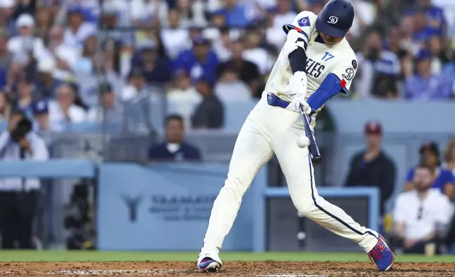 Los Angeles Dodgers' Shohei Ohtani hits a home run during the fifth inning of a baseball game against the Toronto Blue Jays, Saturday, Aug. 9, 2025, in Los Angeles. (AP Photo/Jessie Alcheh)