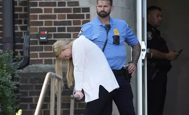 A person walks out of the Annunciation Church's school as police respond to a reported mass shooting, Wednesday, Aug. 27, 2025, in Minneapolis. (AP Photo/Abbie Parr)