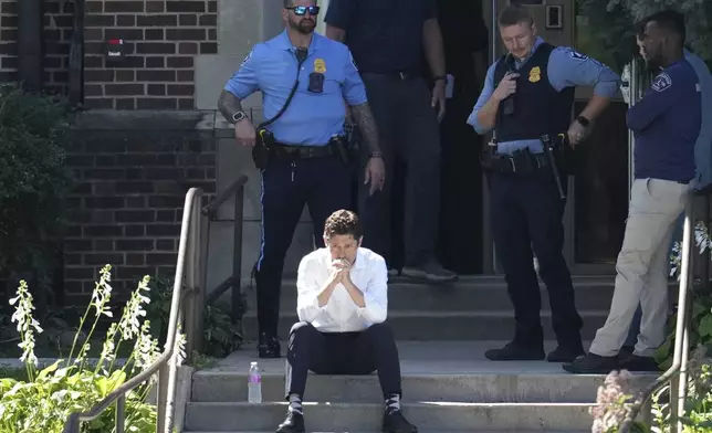 Minneapolis Mayor Jacob Frey sits on steps of the Annunciation Church's school as police respond to a reported mass shooting, Wednesday, Aug. 27, 2025, in Minneapolis. (AP Photo/Abbie Parr)