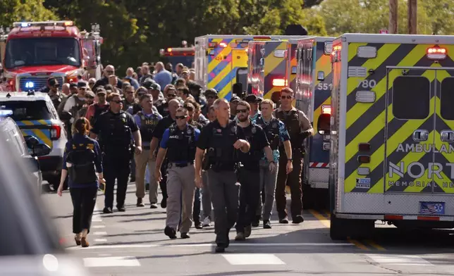 Law enforcement officers gather outside the Annunciation Church's school in response to a reported mass shooting, Wednesday, Aug. 27, 2025, in Minneapolis. (AP Photo/Bruce Kluckhohn)