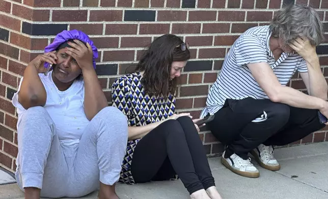 Parents await news of their children's status after a shooting at Annunciation Church on Wednesday morning, Aug. 27, 2025 in Minneapolis. (Richard Tsong-Taatarii/Star Tribune via AP)