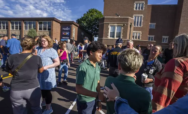Students and parents await news during a mass shooting at the Annunciation Catholic School in Minneapolis on Wednesday, Aug. 27, 2025. (Richard Tsong-Taatarii/Star Tribune via AP)