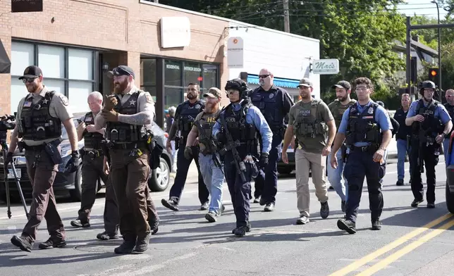 Law enforcement officers gather outside the Annunciation Church's school in response to a reported mass shooting, Wednesday, Aug. 27, 2025, in Minneapolis. (AP Photo/Abbie Parr)