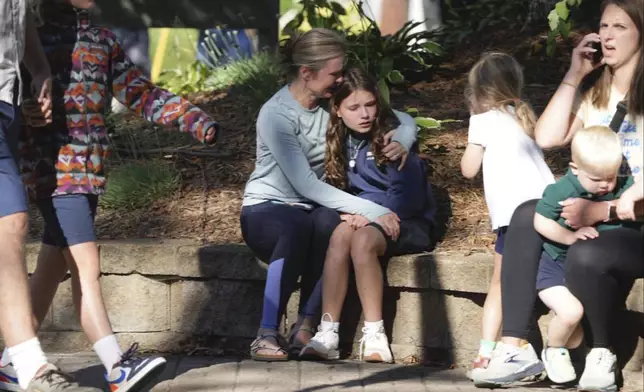 Parents await news of their children's status after a shooting at Annunciation Church on Wednesday, Aug. 27, 2025 in Minneapolis. (Alex Kormann/Star Tribune via AP)/
