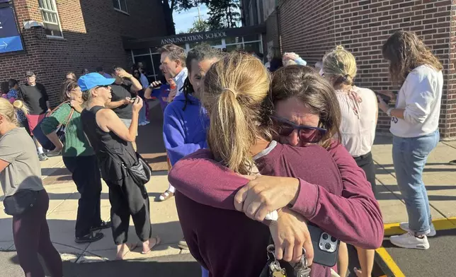 Parents await news of their children after a reported mass shooting at Annunciation Church on Wednesday, Aug. 27, 2025, in Minneapolis. (Richard Tsong-Taatarii/Star Tribune via AP)
