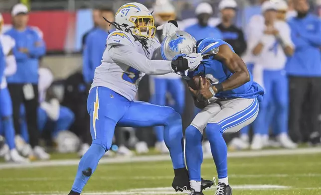 Los Angeles Chargers linebacker Tre'Mon Morris-Brash, left, sacksDetroit Lions quarterback Hendon Hooker, right, in the second half of the Pro Football Hall of Fame NFL preseason game Thursday, July 31, 2025, in Canton, Ohio. (AP Photo/David Richard)