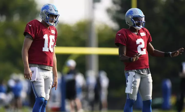 Detroit Lions quarterbacks Jared Goff, left, and Hendon Hooker run drills during NFL football training camp Sunday, Aug. 3, 2025, in Allen Park, Mich. (AP Photo/Ryan Sun)