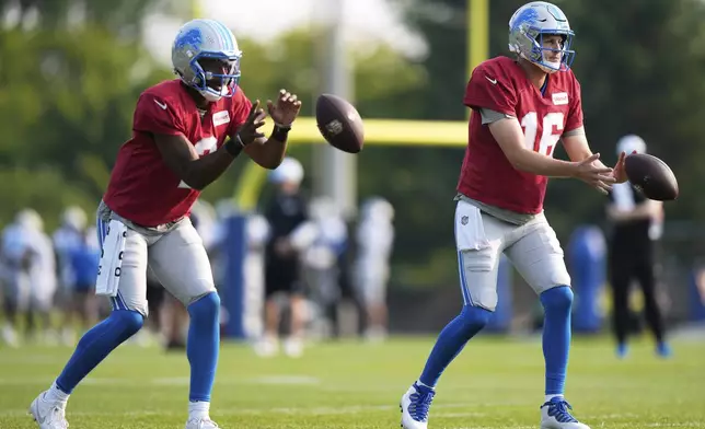 Detroit Lions quarterbacks Jared Goff, right, and Hendon Hooker run drills during NFL football training camp Sunday, Aug. 3, 2025, in Allen Park, Mich. (AP Photo/Ryan Sun)