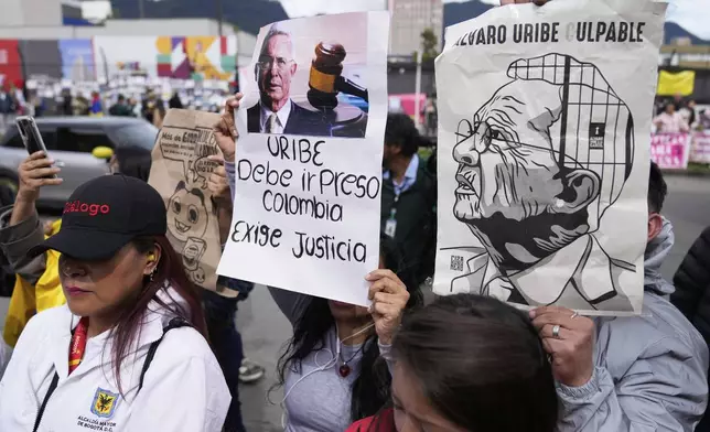 Opponents of former President Alvaro Uribe gather outside the court on the day he was sentenced to 12 years under house arrest for witness tampering and bribery in Bogota, Colombia, Friday, Aug. 1, 2025. (AP Photo/Fernando Vergara)