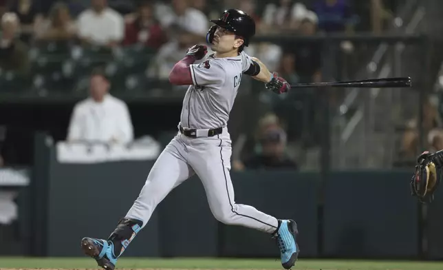 Arizona Diamondbacks' Corbin Carroll hits a sacrifice fly to score a run during the seventh inning of a baseball game against the Athletics, Friday, Aug. 1, 2025, in West Sacramento, Calif. (AP Photo/Scott Marshall)