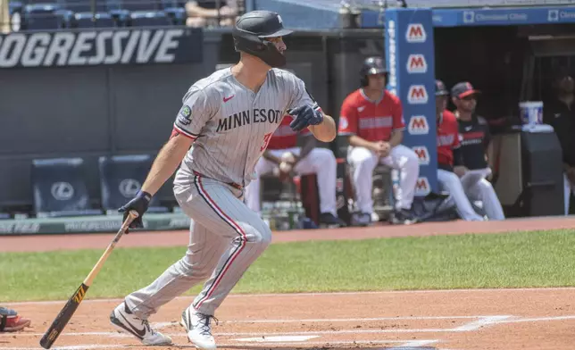 Minnesota Twins' Matt Wallner watches his RBI single off Cleveland Guardians relief pitcher Joey Cantillo during the first inning of a baseball game, Sunday, Aug. 3, 2025, in Cleveland. (AP Photo/Phil Long)
