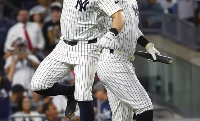 New York Yankees' Ben Rice, left, celebrates with Aaron Judge, right, after hitting a home run during the third inning of a baseball game against the Washington Nationals, Monday, Aug. 25, 2025, in New York. (AP Photo/Noah K. Murray)