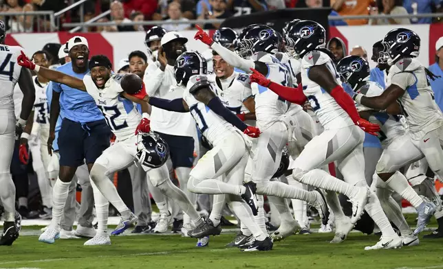 Tennessee Titans cornerback Davion Ross celebrates after recovering a fumble Tampa Bay Buccaneers during the second half of an NFL preseason football game on Saturday, Aug. 9, 2025, in Tampa, Fla. (AP Photo/Jason Behnken)