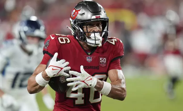 Tampa Bay Buccaneers cornerback Roman Parodie intercepts a pass and returns it jar,for a touchdown against the Tennessee Titans during the second half of an NFL preseason football game on Saturday, Aug. 9, 2025, in Tampa, Fla. (AP Photo/Chris O'Meara)