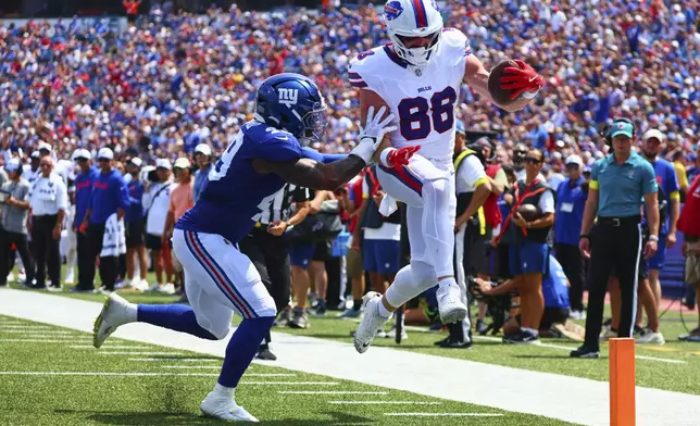 Buffalo Bills' Dawson Knox (88) runs past Buffalo Bills' Keonta Jenkins (49) for a touchdown during the first half of an NFL preseason football game Saturday, Aug. 9, 2025, in Orchard Park, N.Y. (AP Photo/Jeffrey T. Barnes)
