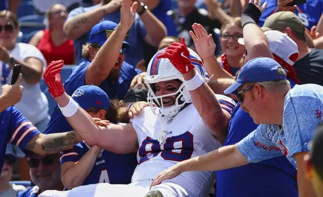 Buffalo Bills' Dawson Knox (88) celebrates with fans after scoring a touchdown during the first half of an NFL preseason football game against the New York Giants Saturday, Aug. 9, 2025, in Orchard Park, N.Y. (AP Photo/Jeffrey T. Barnes)
