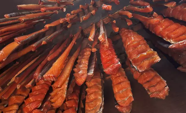 Salmon strips hang inside Gloria Simeon's smokehouse in Bethel, Alaska, on June 18, 2025. (AP Photo/Mark Thiessen)