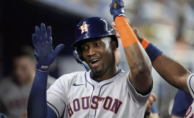 Houston Astros' Jesus Sanchez (4) celebrates after coming home on a single by Carlos Correa in the fourth inning of a baseball game against the Miami Marlins, Monday, Aug. 4, 2025, in Miami. (AP Photo/Rebecca Blackwell)