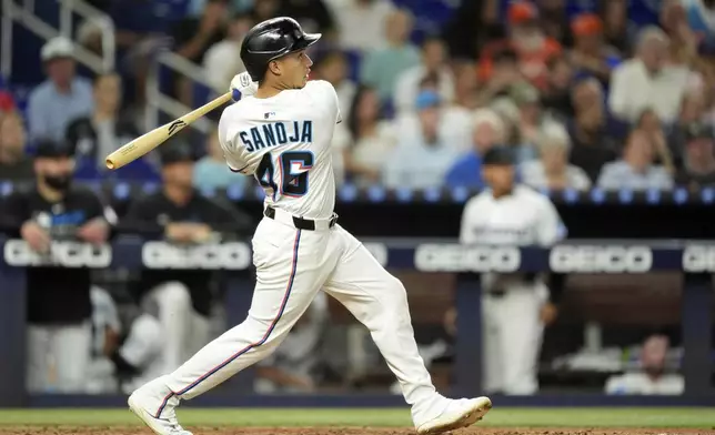 Miami Marlins' Javier Sanoja hits a home run in the seventh inning of a baseball game against the Houston Astros, Monday, Aug. 4, 2025, in Miami. (AP Photo/Rebecca Blackwell)