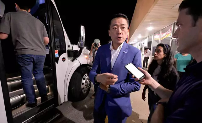 Texas House Democratic Caucus Chair Gene Wu boards a bus with other legislators after speaking at a press conference along side Illinois Governor JB Pritzker at the Democratic Party of DuPage County office in Carol Stream, IL on Sunday, Aug. 3, 2025. (AP Photo/Mark Black)