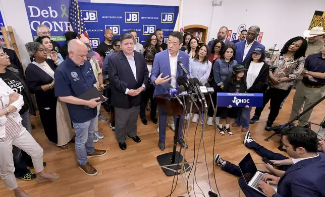 Texas House Democratic Caucus Chair Gene Wu along with other members of the Texas House are joined by Illinois Governor JB Pritzker as they speak about Texas Republican plans to redraw the House map office during a press conference at the Democratic Party of DuPage County office in Carol Stream, IL on Sunday, Aug. 3, 2025. (AP Photo/Mark Black)