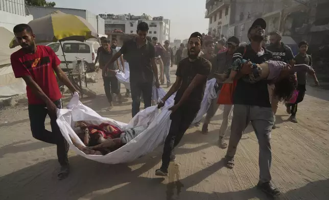 The bodies of Palestinians killed by an Israeli airstrike are brought to Shifa Hospital in Gaza City Monday, Aug. 11, 2025. (AP Photo/Jehad Alshrafi)