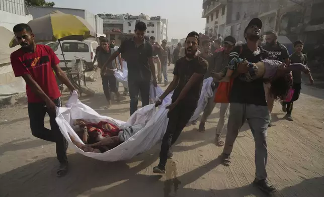 The bodies of Palestinians killed by an Israeli airstrike are brought to Shifa Hospital in Gaza City Monday, Aug. 11, 2025. (AP Photo/Jehad Alshrafi)