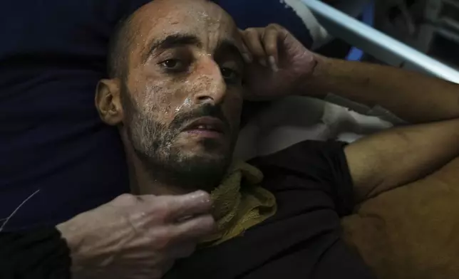 A Palestinian patient sweats during a heat wave, inside a warehouse set up in the yard of Shifa Hospital in Gaza City where there is no air conditioning, Wednesday, Aug. 13, 2025. (AP Photo/Jehad Alshrafi)