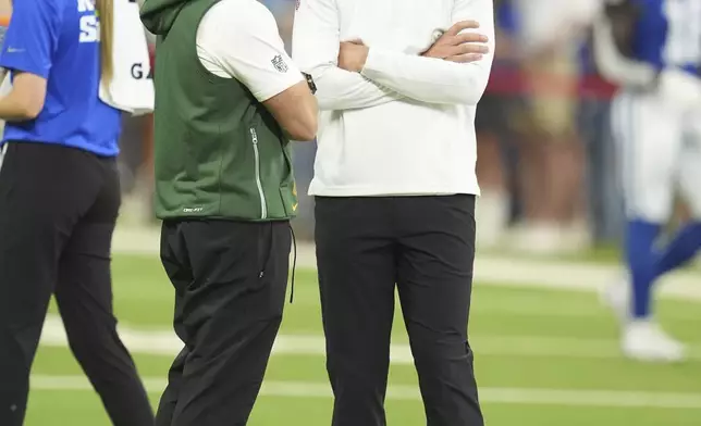 Green Bay Packers head coach Matt LaFleur, left, talks with Indianapolis Colts head coach Shane Steichen before an preseason NFL football game, Saturday, Aug. 16, 2025, in Indianapolis. (AP Photo/Michael Conroy)