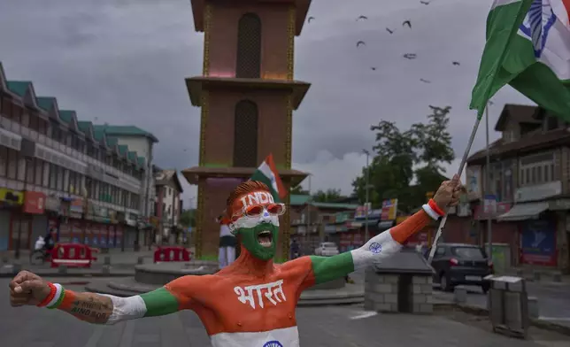 An Indian man painted with the Indian national flag shouts slogans as he celebrates India's Independence Day in Srinagar, Indian controlled Kashmir, Friday, Aug. 15, 2025. (AP Photo/Dar Yasin)