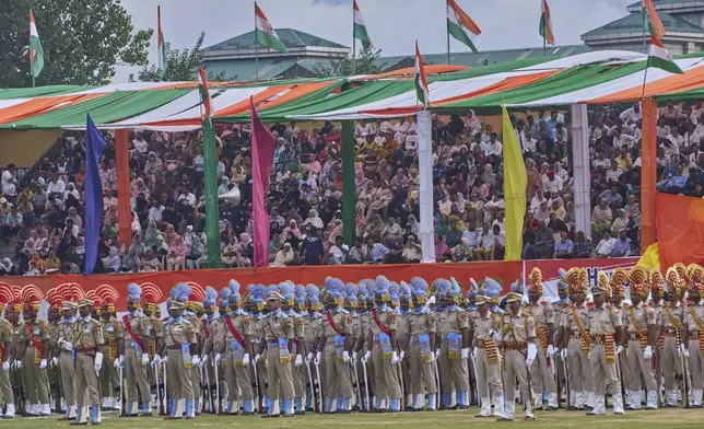 People watch an Independence Day parade in Srinagar, Indian controlled Kashmir, Friday, Aug. 15, 2025. (AP Photo/Dar Yasin)