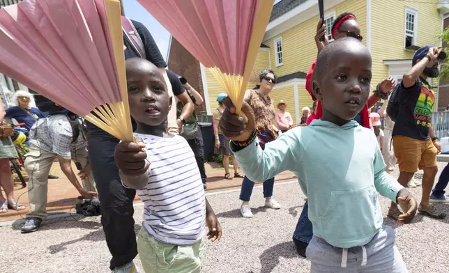 FILE - Levis Martin, left, and his brother Daniel dance with fans during a Juneteenth celebration in Portsmouth, N.H, on June 19, 2025. (AP Photo/Michael Dwyer, File)