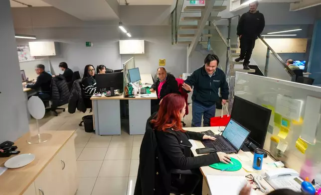 Actor Sebastián Solorza, who has Down syndrome and aims to run for president as an independent candidate, waves to a colleague in Santiago, Chile, Thursday, July 31, 2025. (AP Photo/Esteban Felix)