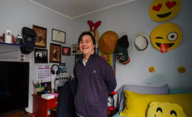 Actor Sebastián Solorza, who has Down syndrome and aims to run for president as an independent candidate, smiles during an interview at his home in Santiago, Chile, Thursday, July 31, 2025. (AP Photo/Esteban Felix)