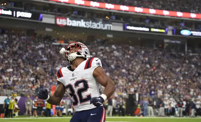 New England Patriots running back TreVeyon Henderson (32) celebrates after scoring during the first half of a preseason NFL football game against the Minnesota Vikings Saturday, Aug. 16, 2025, in Minneapolis. (AP Photo/Bruce Kluckhohn)