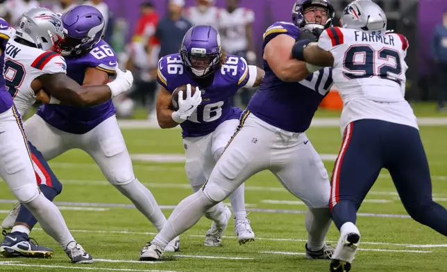 Minnesota Vikings running back Zavier Scott (36) runs with the ball during the first half of a preseason NFL football game against the New England Patriots Saturday, Aug. 16, 2025, in Minneapolis. (AP Photo/Bruce Kluckhohn)