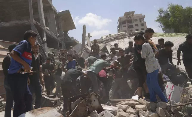 Palestinians struggle to collect humanitarian aid airdropped by parachutes into Gaza City, northern Gaza Strip, Thursday, Aug. 7, 2025. (AP Photo/Jehad Alshrafi)